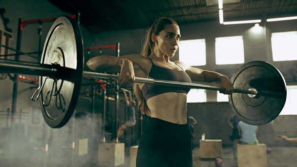 fit-young-woman-lifting-barbells-working-out-in-a-ZJ6VX3C.jpg